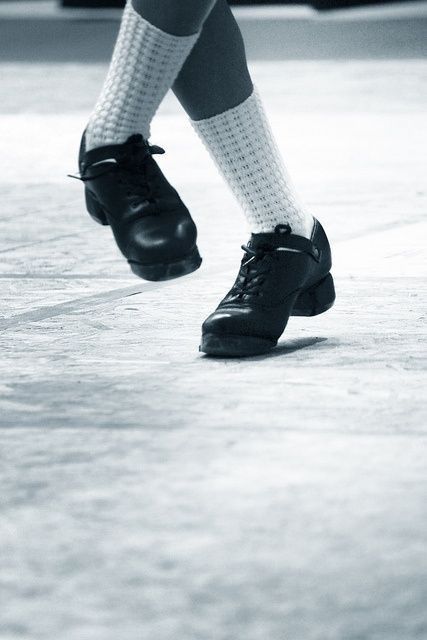 black and white photograph of person wearing socks and shoes