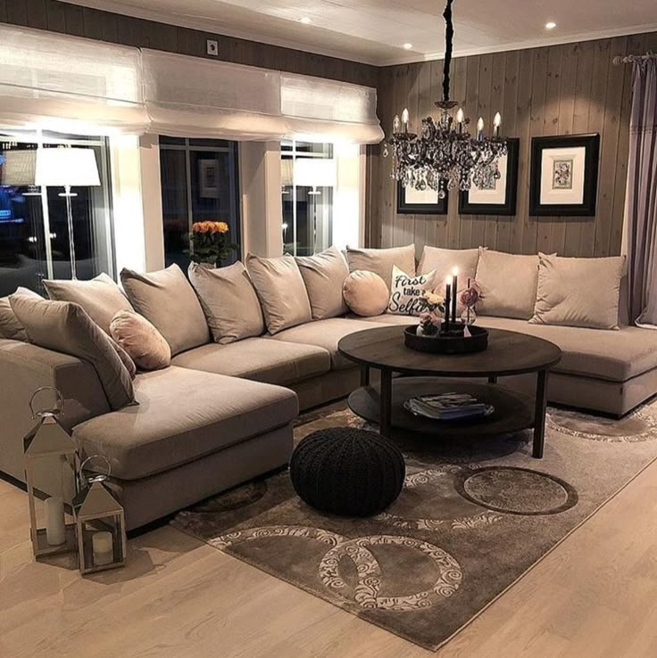 a living room filled with furniture and a chandelier