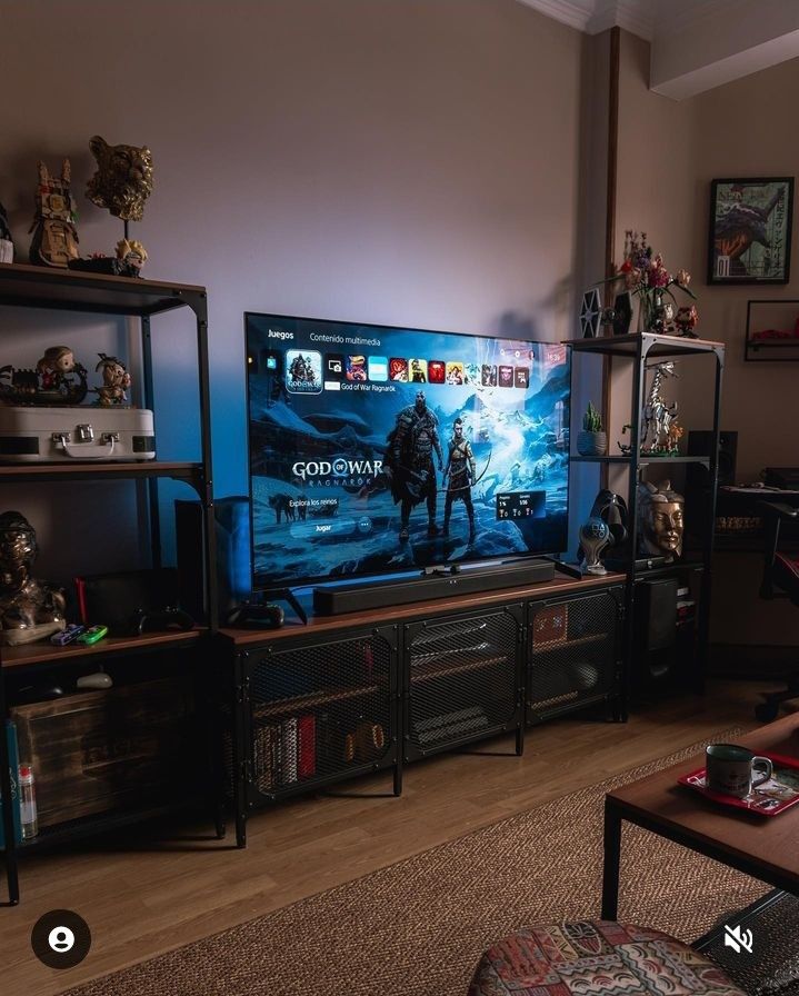 a flat screen tv sitting on top of a wooden entertainment center in a living room