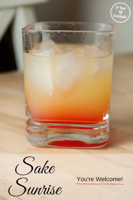 an orange and yellow drink sitting on top of a wooden table