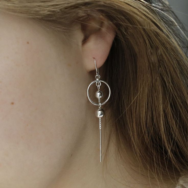 Slinky and versatile, our sterling silver orbit threader earrings are high value and hard-working. The beauty of threaders is that you can wear them solo in so many different ways, and they bring some length to an ear-stack. Martha Jackson's orbit threaders feature two polished silver balls; one in orbit and the other dangling. The threader is made from highly polished sterling silver chain. If you are looking for lightweight earrings that are comfortable and stand out, these are for you. As you'd expect from Martha Jackson, our sterling silver orbit threader earrings are made from premium recycled sterling silver. Because gifting shouldn't cost the earth. Or blow the bank. And because we want to be kind to the skin, expect hypoallergenic and nickel-free silver. All our jewellery comes wit Silver Sterling Silver Threader Earrings, Dainty Sterling Silver Linear Earrings, Adjustable Silver Sterling Threader Earrings, Hypoallergenic Sterling Silver Long Drop Linear Earrings, Dainty Silver Linear Pierced Earrings, Dainty Sterling Silver Linear Pierced Earrings, Hypoallergenic Long Drop Sterling Silver Linear Earrings, Nickel-free Sterling Silver Threader Earrings, Nickel-free Silver Sterling Threader Earrings