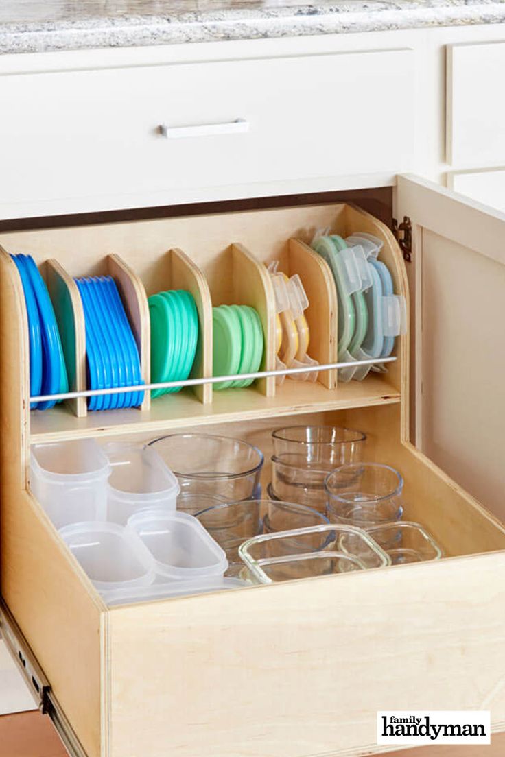 an open drawer with plates and cups in it