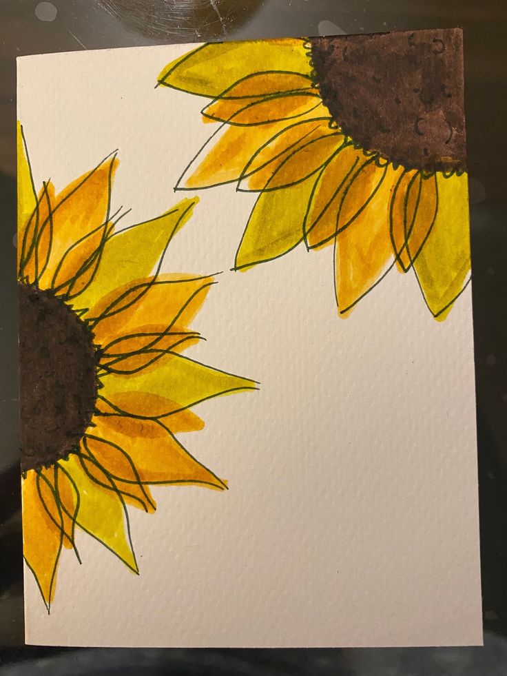 a piece of paper that has been painted with sunflowers in yellow and brown