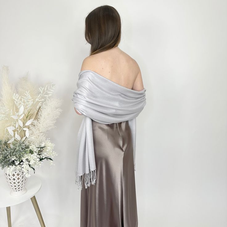 A silver pashmina scarf is versatile and will go with any bridesmaid dress and match any wedding theme. Its simply a classic and a must for winter and chilly outdoor weddings! Our wedding pashminas are extremely soft and will keep your guests warm at your wedding reception and they are great pashmina wedding favors for your guests as they are high quality. A prefect bridesmaid proposal gift is a silver bridesmaid pashmina! A pashmina scarf is also a great favor gift for guests at a bridal shower Winter Wedding Pashmina Shawl, Elegant Pashmina Shawl For Evening, Formal Elegant Pashmina Shawl, Elegant Winter Wedding Pashmina Shawl, Elegant Winter Pashmina Shawl, Elegant Winter Formal Pashmina Shawl, Elegant Winter Pashmina Shawl For Formal Occasions, Elegant Formal Pashmina Scarves, Elegant Pashmina Shawl For Wedding