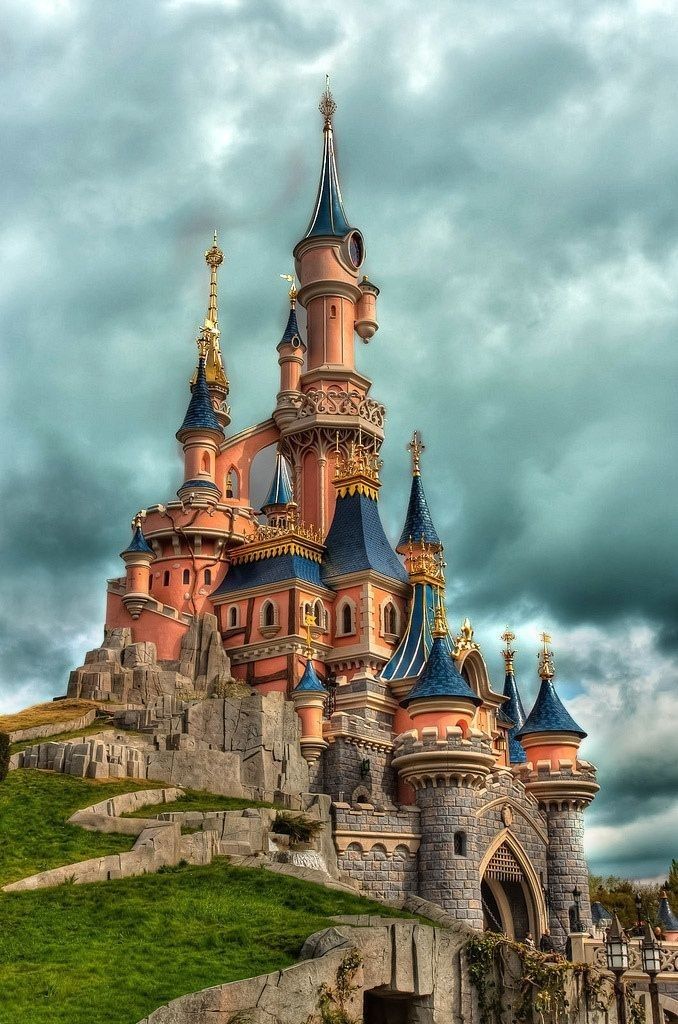 the castle is built on top of a hill and has many spires in it