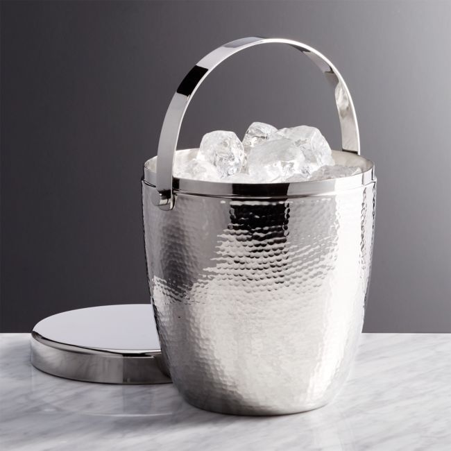 a metal bucket with ice in it on a table