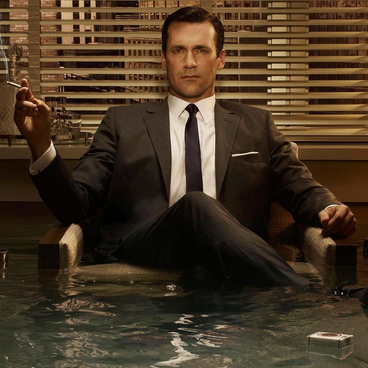 a man in a suit and tie sitting in a flooded room