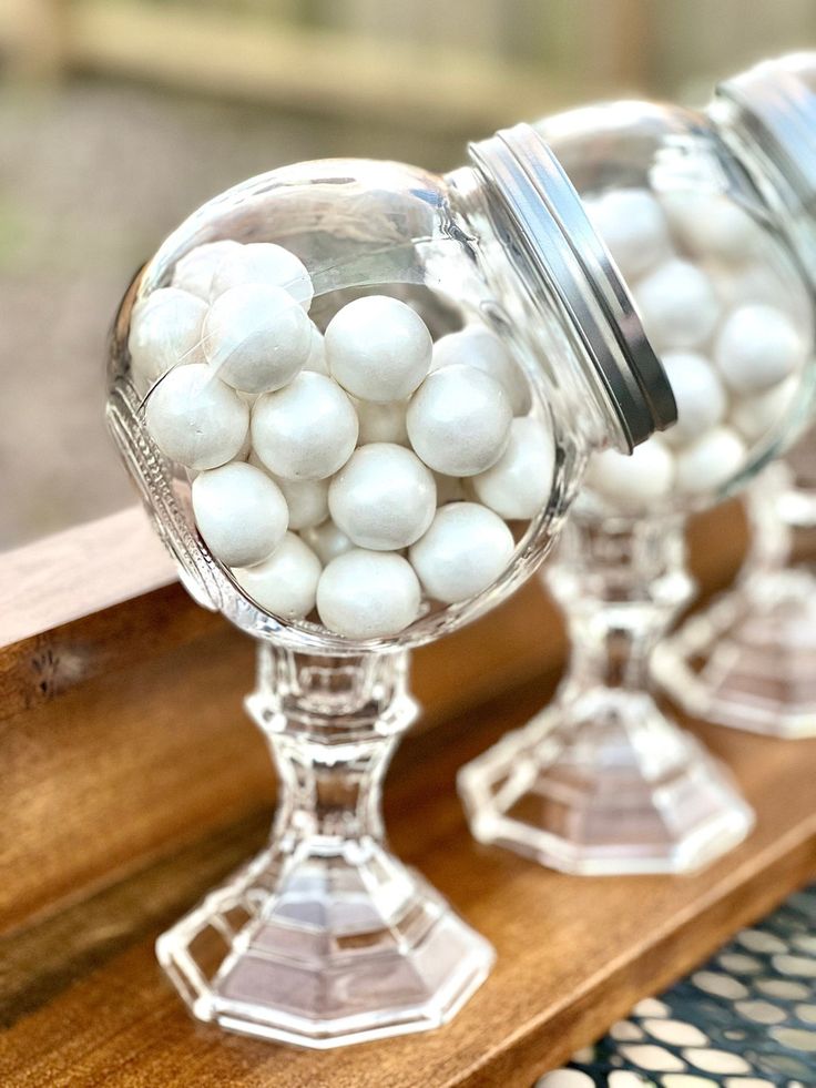 three glass vases filled with white candies