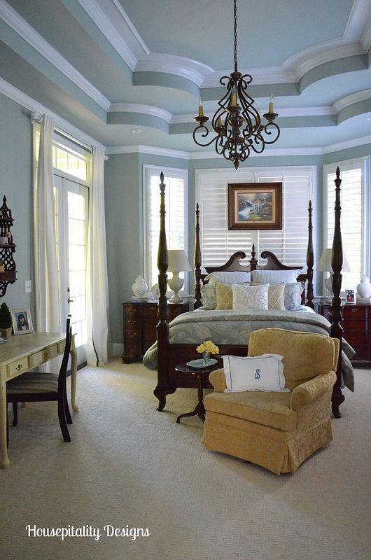 a bedroom with blue walls and white carpet