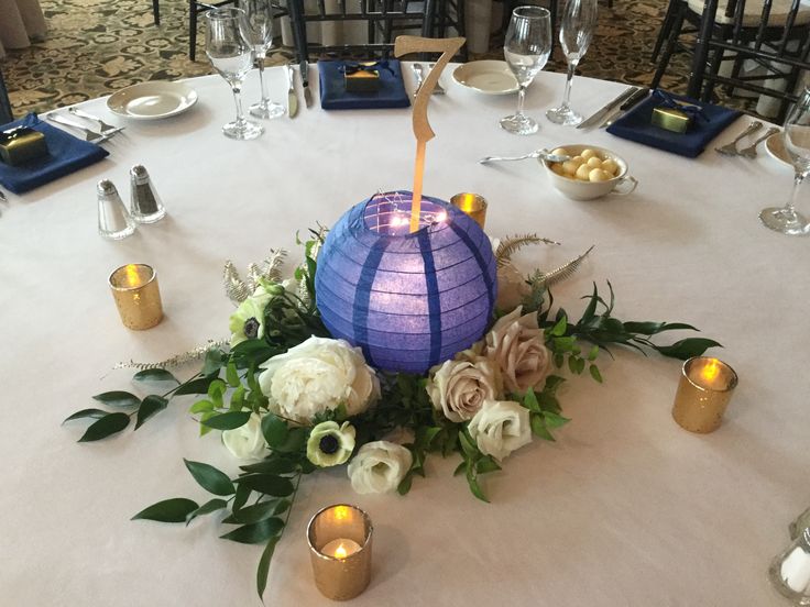 a table is set with candles, flowers and other decorations for a party or celebration