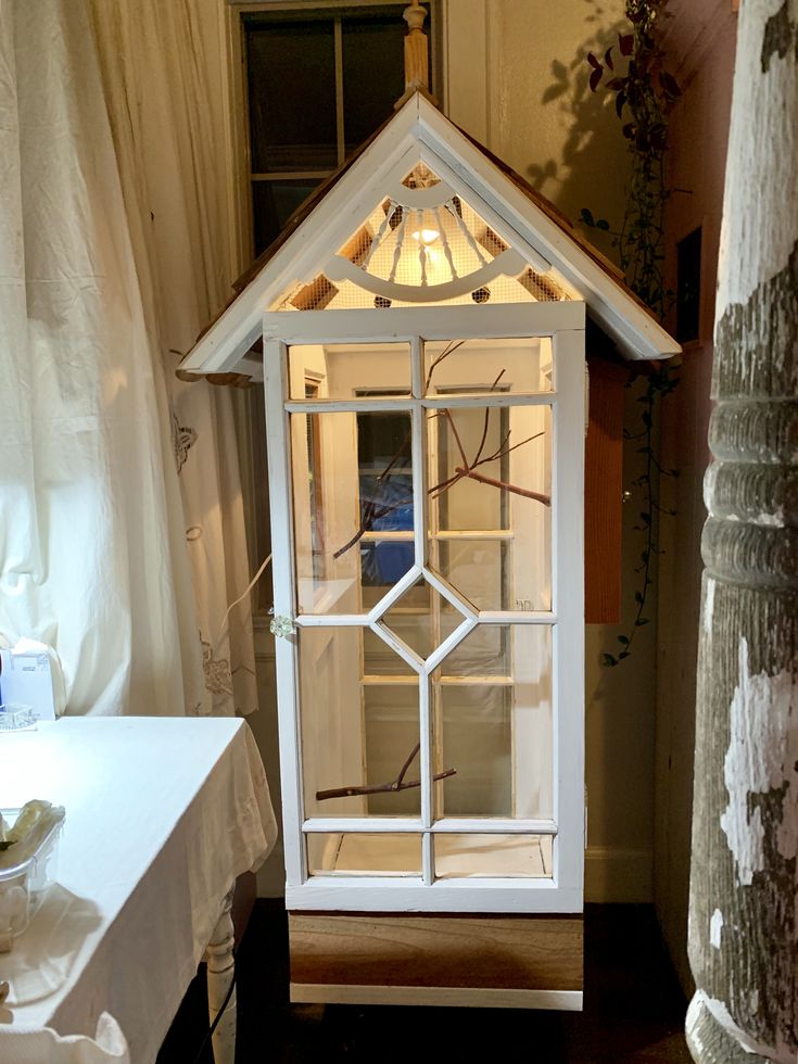 a doll house made out of an old window