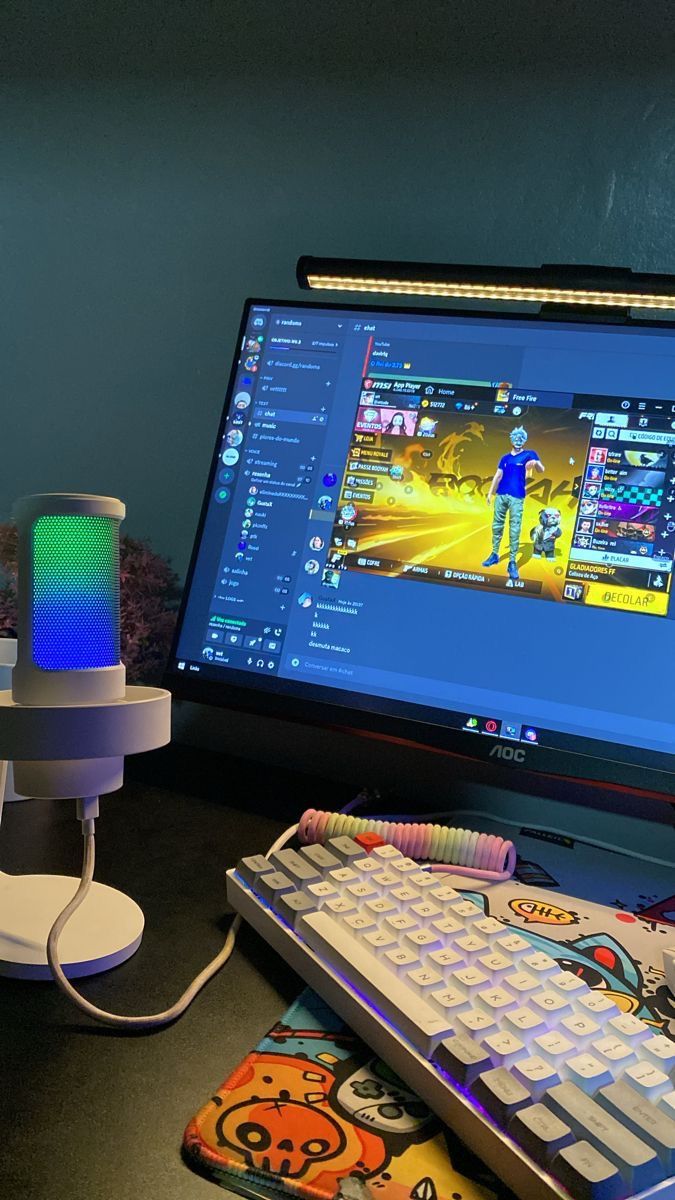 a computer monitor sitting on top of a desk next to a keyboard and mouse pad