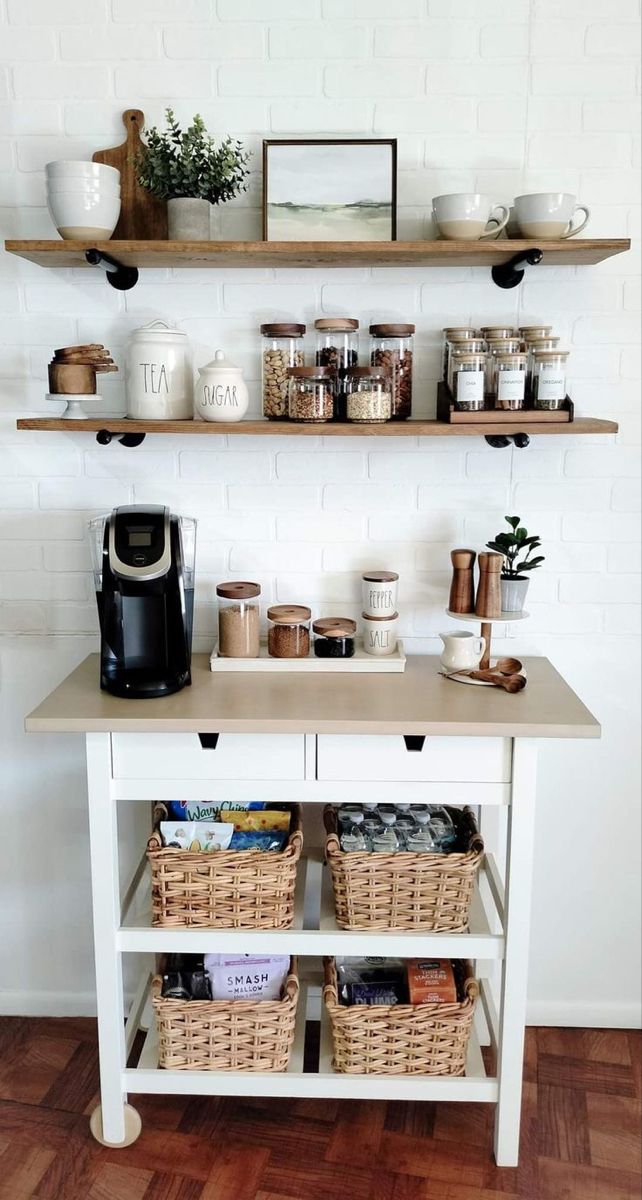 a kitchen island with baskets and coffee cups on it