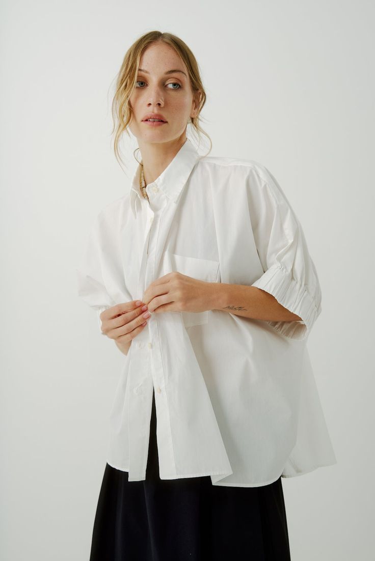 Update to our Le Shirt, we cropped it off mid way to wear with your high waisted and full skirts. Same great body and sleeve detail with volume everyday drama. Front chest pocket and button placket make this your fave classic. Worn here with Monrow pant 100% Cotton | Laundered for a relaxed finish Small batch made in LA | Organic Poplin Vintage Sunnies, Army Pants, Pearl Accessories, Cashmere Jacket, Full Skirts, Easy Tiger, Caged Sandals, Black Tank Dress, Black Aviators