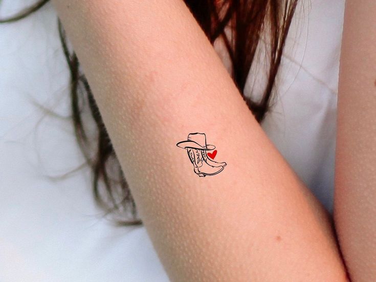 a woman's arm with a small tattoo on the left side of her arm