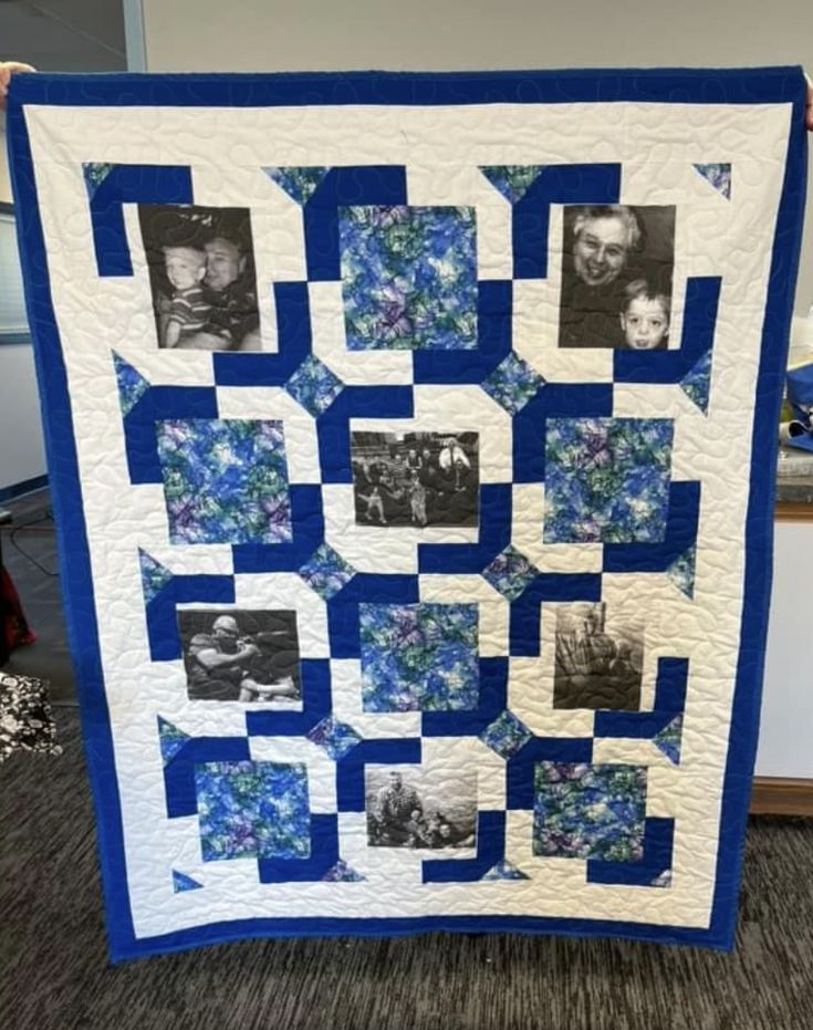 a blue and white quilt with four photos on the front, two are in squares