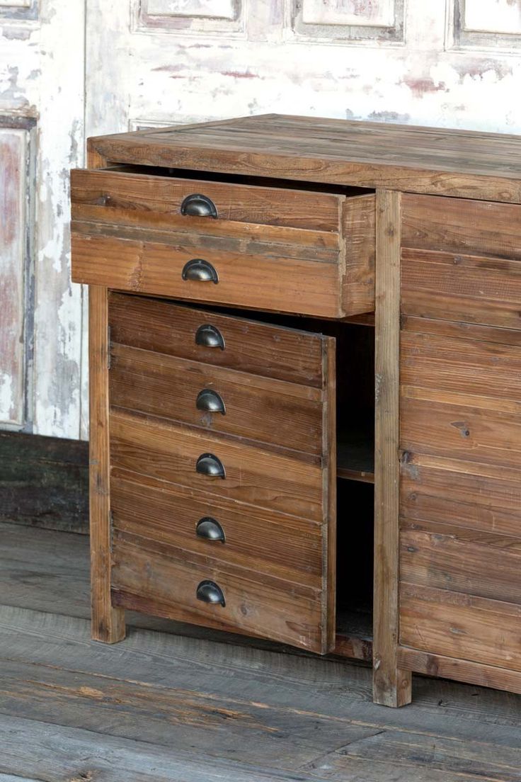 an old wooden cabinet with three drawers on the bottom and one drawer at the top