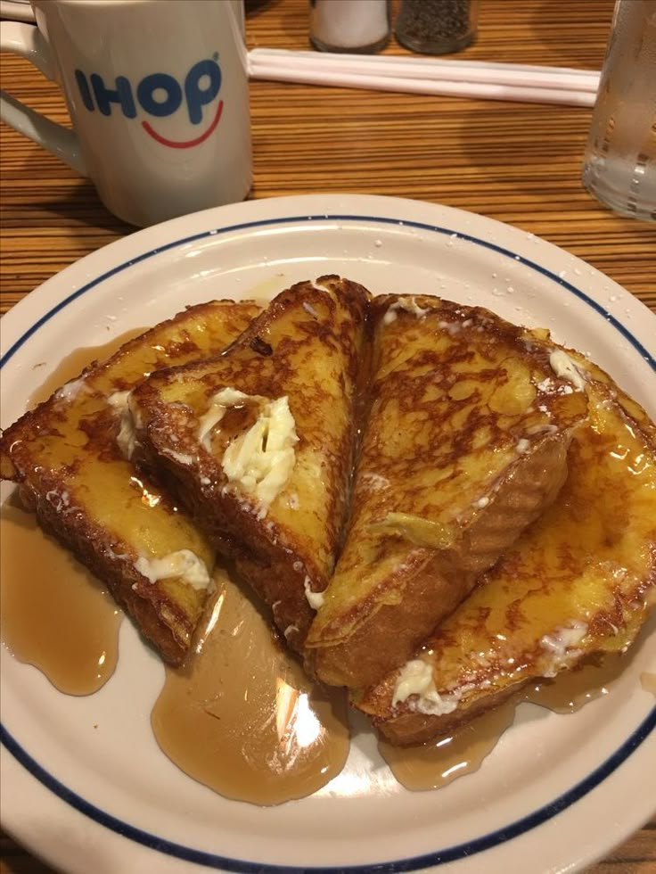 two pieces of french toast on a plate with caramel sauce