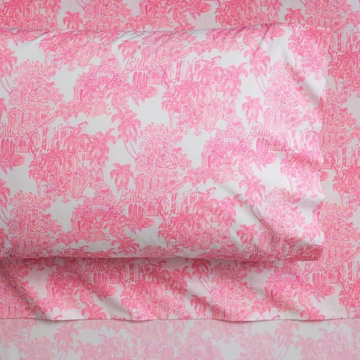 the pink and white bedding is made up of two sheets, one with an intricate design on it