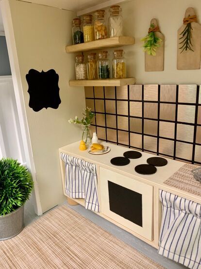 a kitchen with an oven next to a potted plant