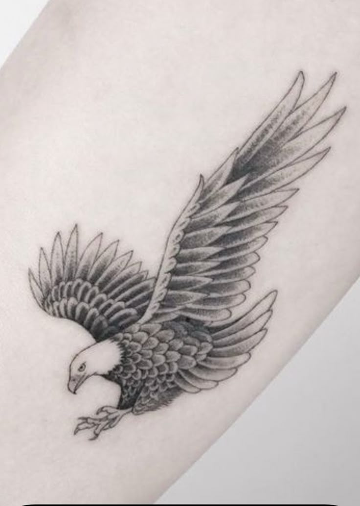 an eagle tattoo is shown on the arm