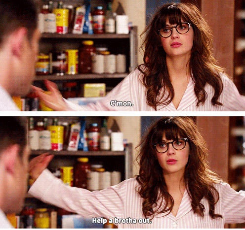 a woman with glasses talking to a man in the kitchen