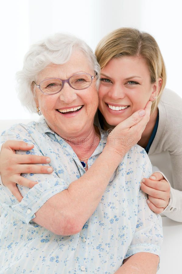 an older woman hugging her younger lady - stock photo - images