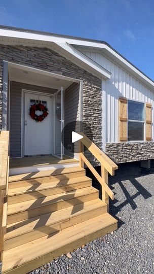 a small home with steps leading to the front door