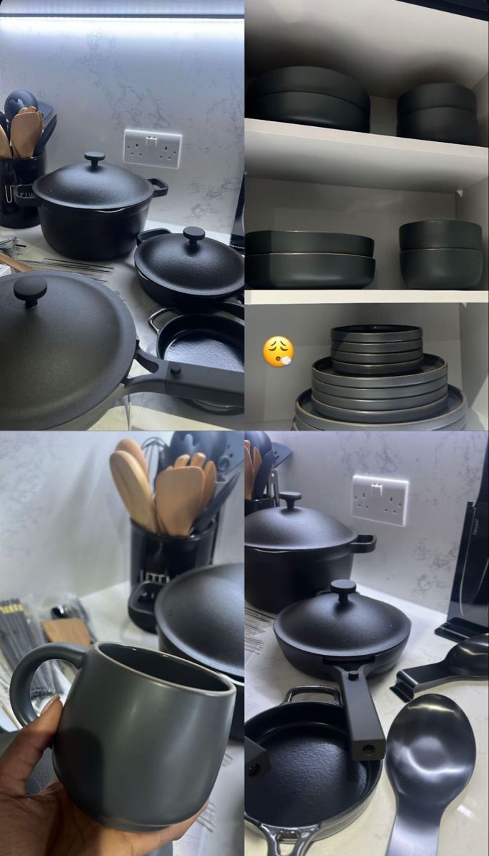 there are many black pots and pans on the shelves in this kitchen set up