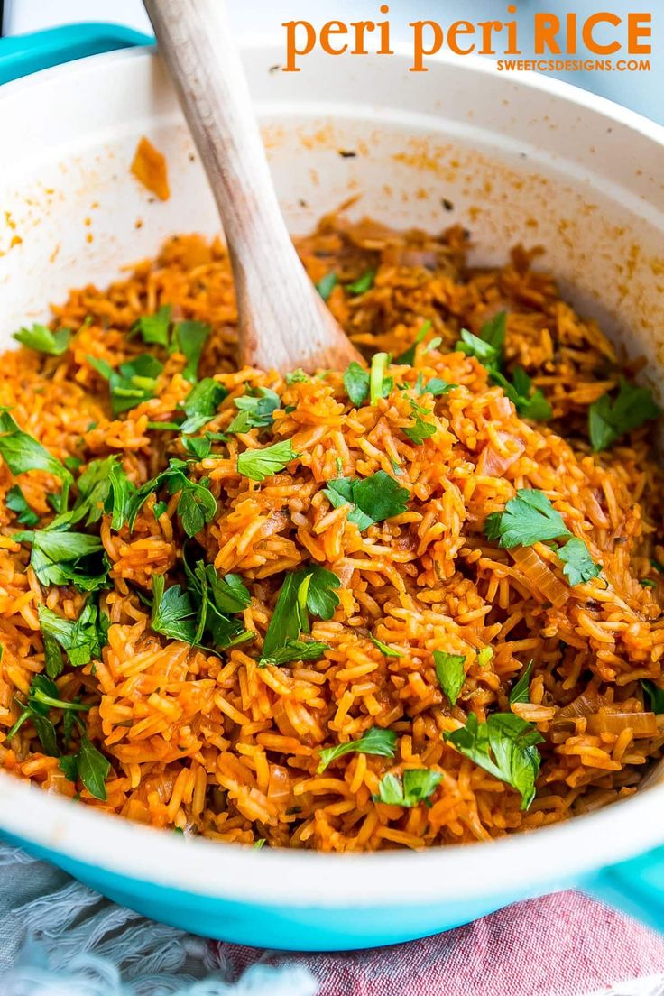 mexican rice with cilantro and parsley in a white bowl on a blue towel