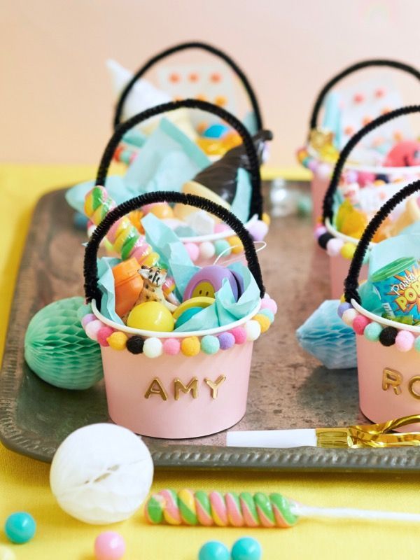 candy buckets are sitting on a tray with candies