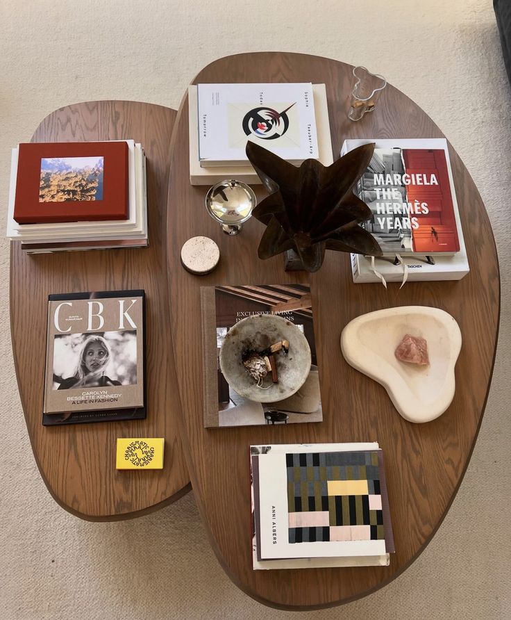 a coffee table topped with books and other items