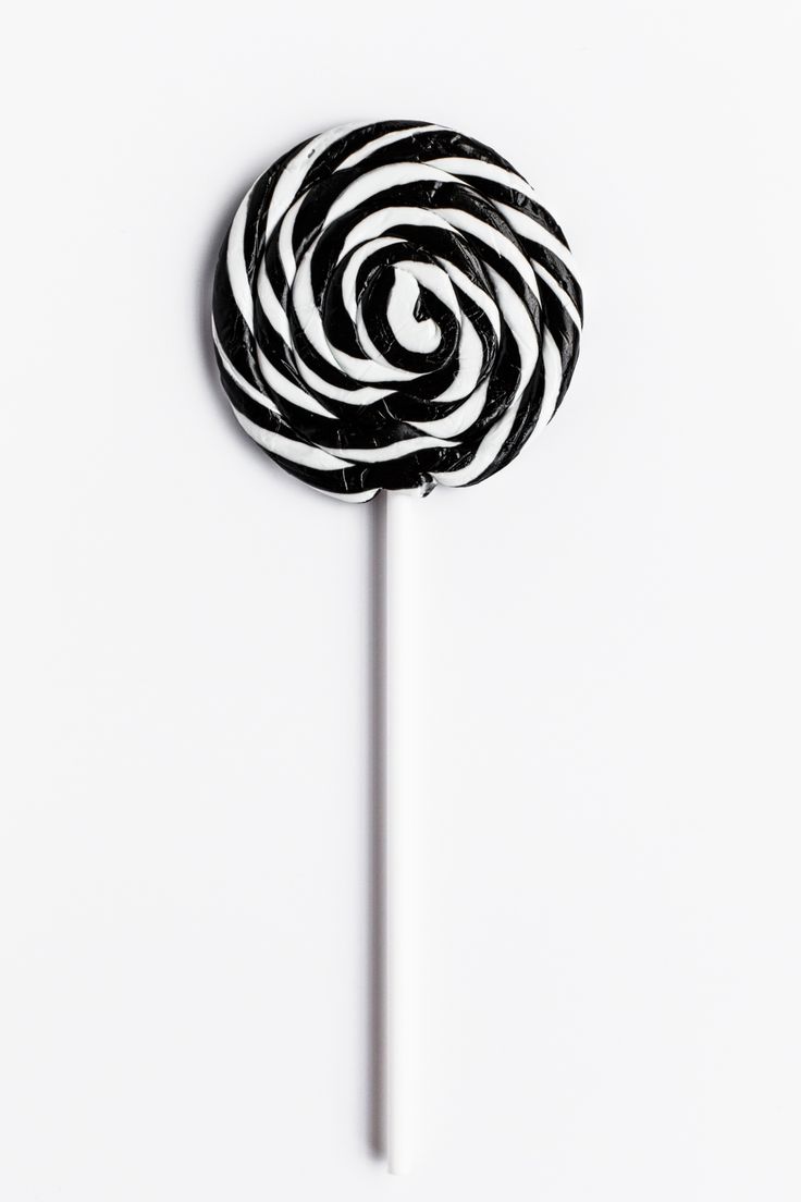 a black and white lollipop on a stick