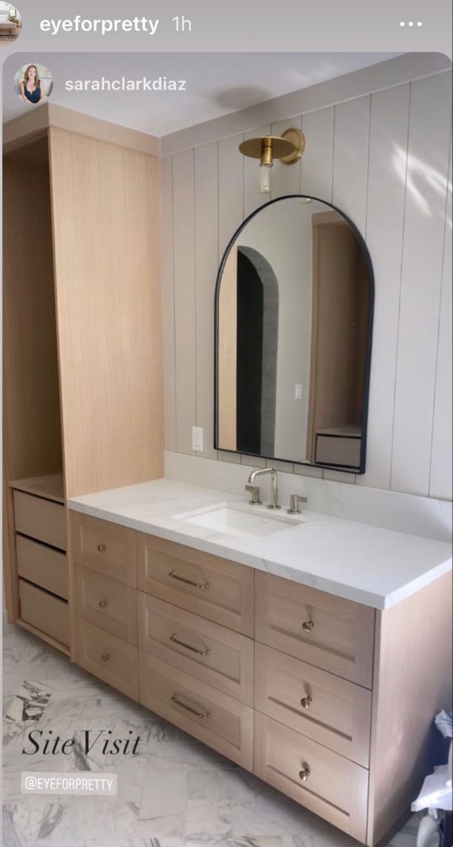 a bathroom vanity with two sinks and a large mirror