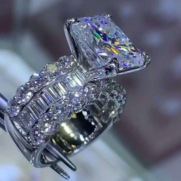 an engagement ring and wedding band are shown in this close up photo from the side