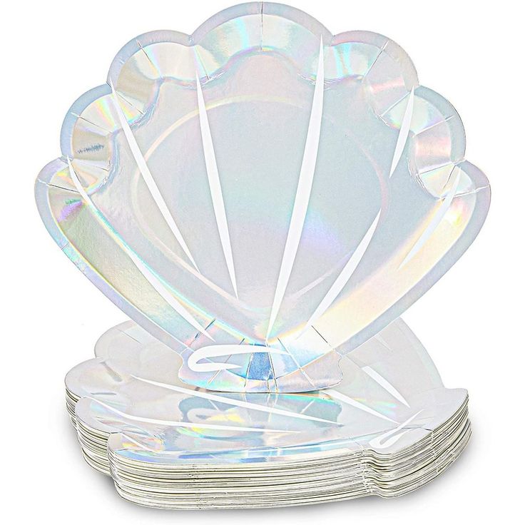 a stack of clear glass plates on top of each other with an intricate shell design