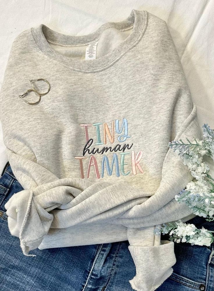 Whether you are a mom, daycare teacher, elementary teacher, babysitter or the best yet...Grandma you need this shirt!   Anyone would agree, this is a job!!  Our Tiny Human Tamer says it all!  Perfect for everyday paired with your favorite jeans or leggings, this one is a cutie! Shown here in oatmeal heather with multiple thread colors. Features: 50% USA cotton, 50% polyester Pill-resistant air jet yarn Made with 50% sustainably and fairly grown USA cotton These are unisex sizing,  Not pre-shrunk Gift For Daycare Provider, Babysitter Gift Ideas, Daycare Provider Christmas Gifts, Babysitter Outfit Ideas, Babysitter Christmas Gifts, Gifts For Daycare Teachers, Daycare Teacher Christmas Gifts, Daycare Teacher Outfits, Daycare Outfits