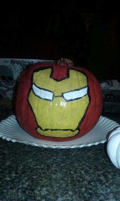 a decorated pumpkin with the face of iron man on it