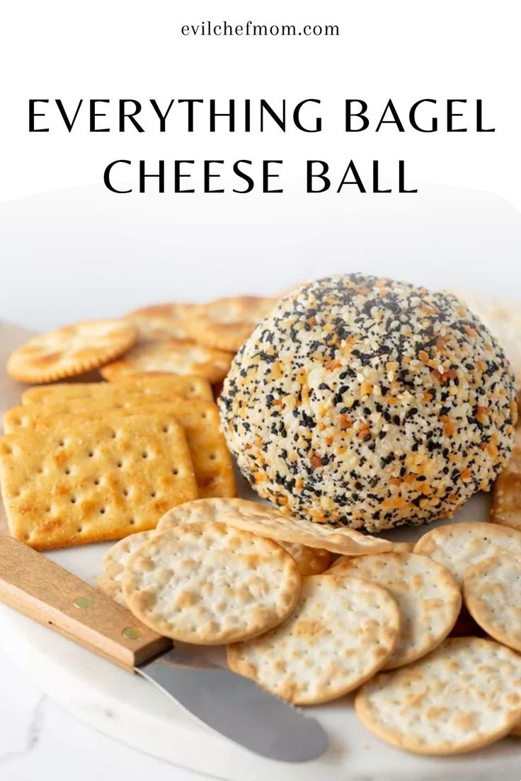 everything bagel cheese ball on a plate with crackers next to it and the text overlay reads everything bagel cheese ball