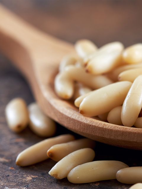 a wooden spoon filled with macaroni and cheese