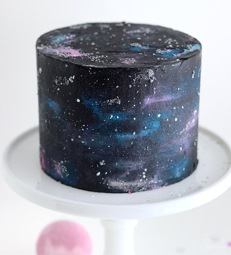 a space themed cake on a white plate