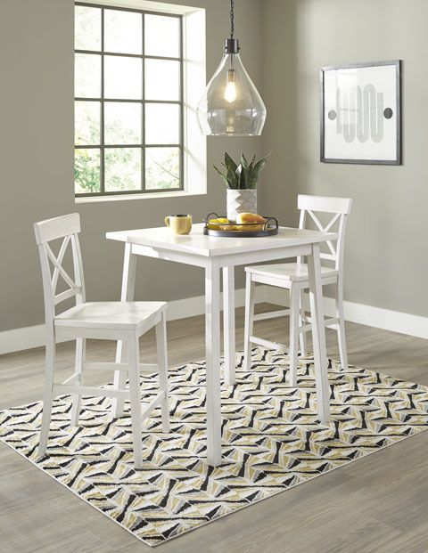 a dining room table and chairs with a rug in front of the table on the floor