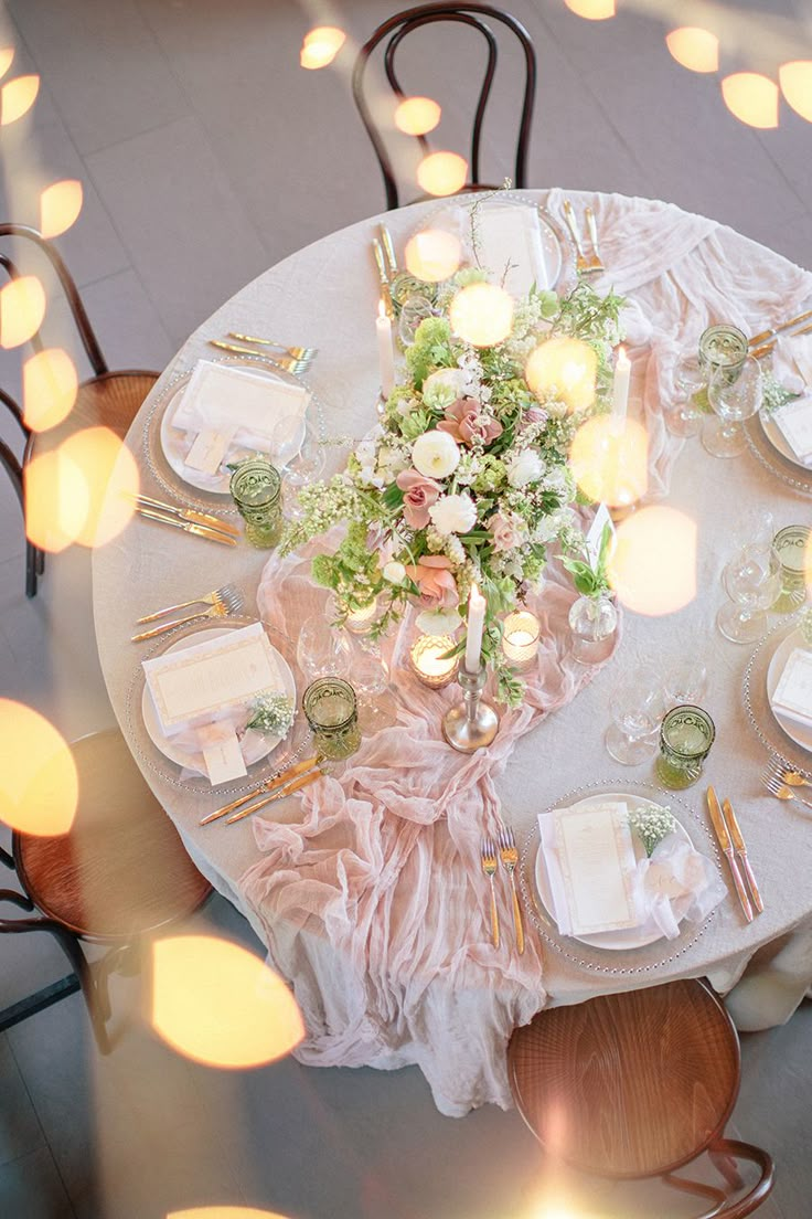 an overhead view of a table set with plates, napkins and flowers on it