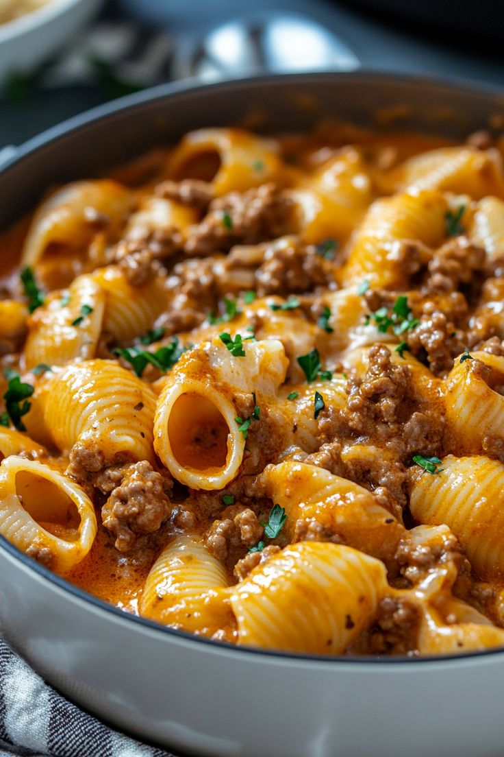 a bowl filled with pasta and meat sauce