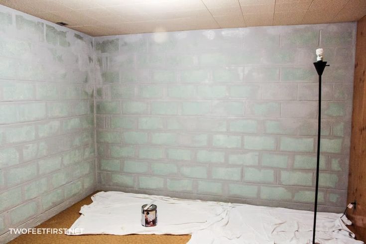 a room that has some paint on the wall and a can of beer in it