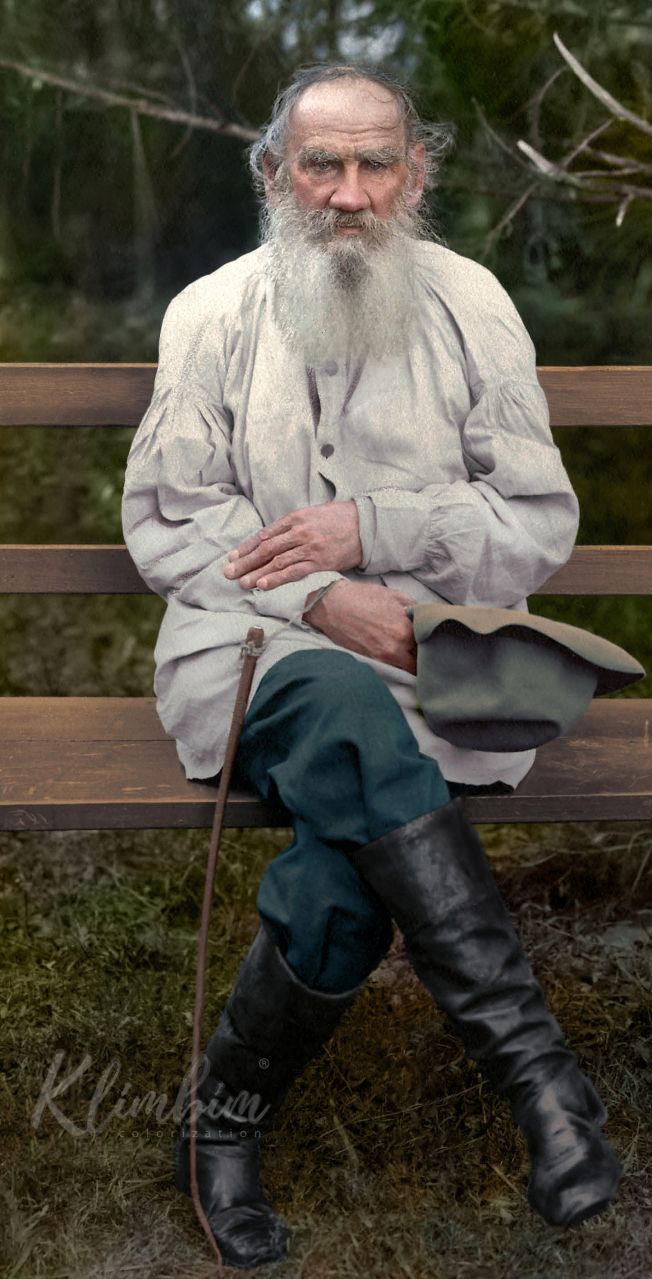 an old man with a long white beard sitting on a bench