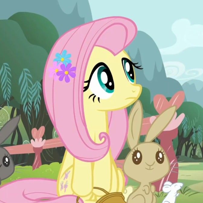 two little ponys sitting next to each other in front of some flowers and trees