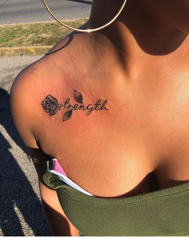 a woman with a tattoo that says strength on her chest