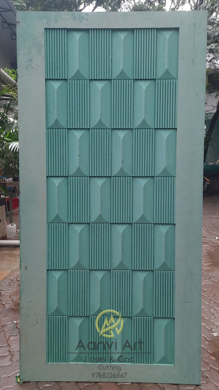 a large green tile wall on the side of a building