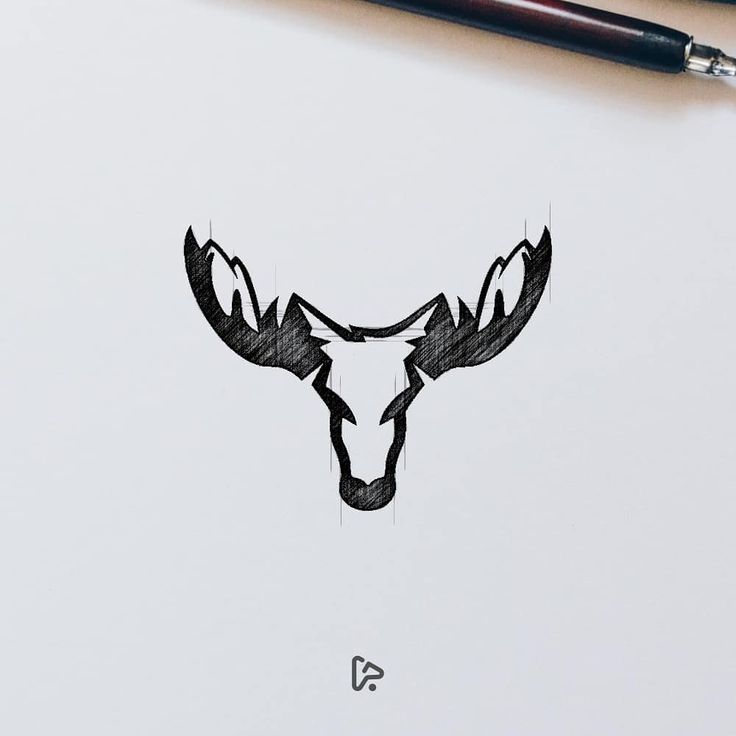 a drawing of a deer's head with antlers in the middle on paper